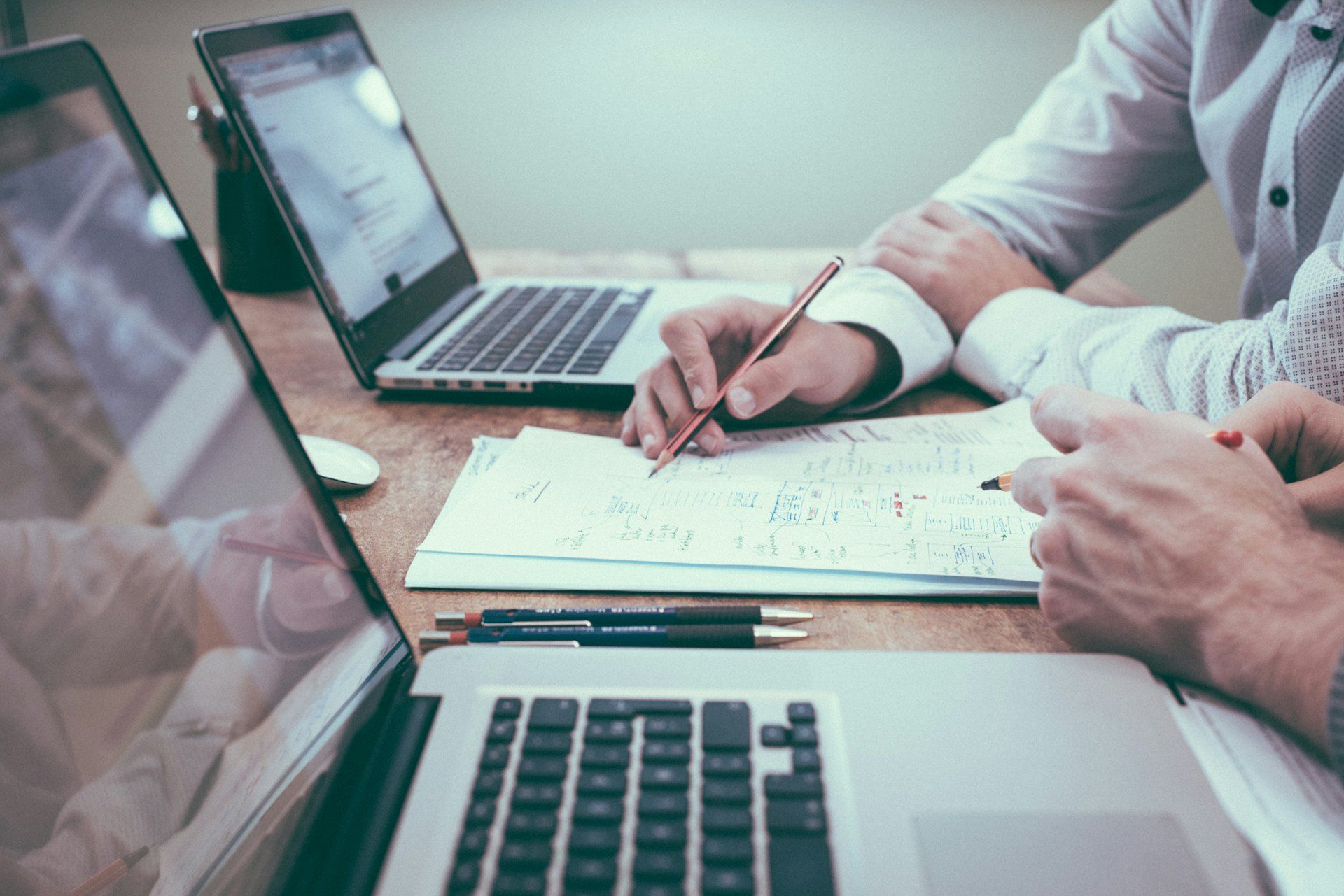 A financial advisory meeting with documents and a laptop