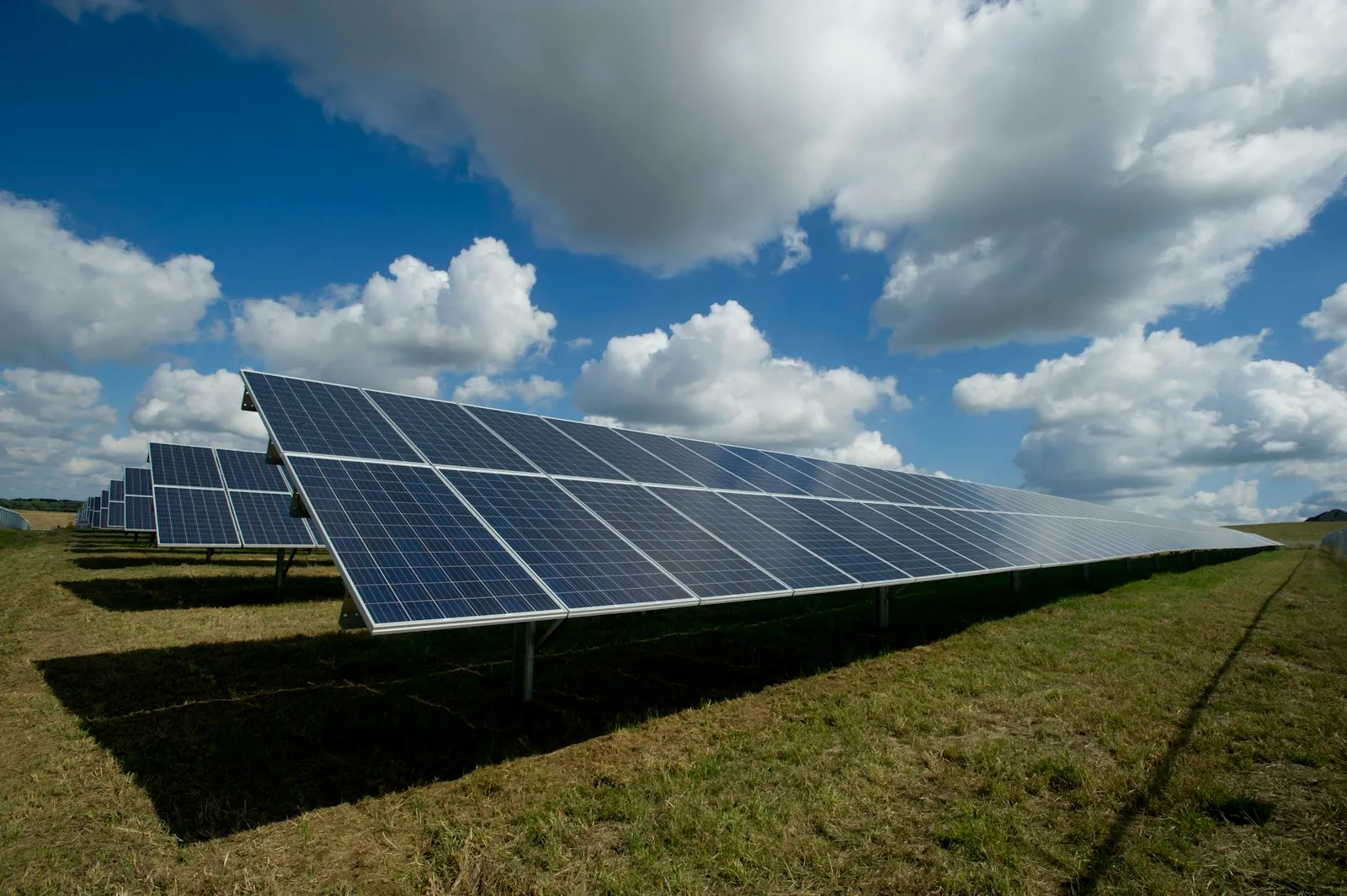 A solar energy farm under a blue sky