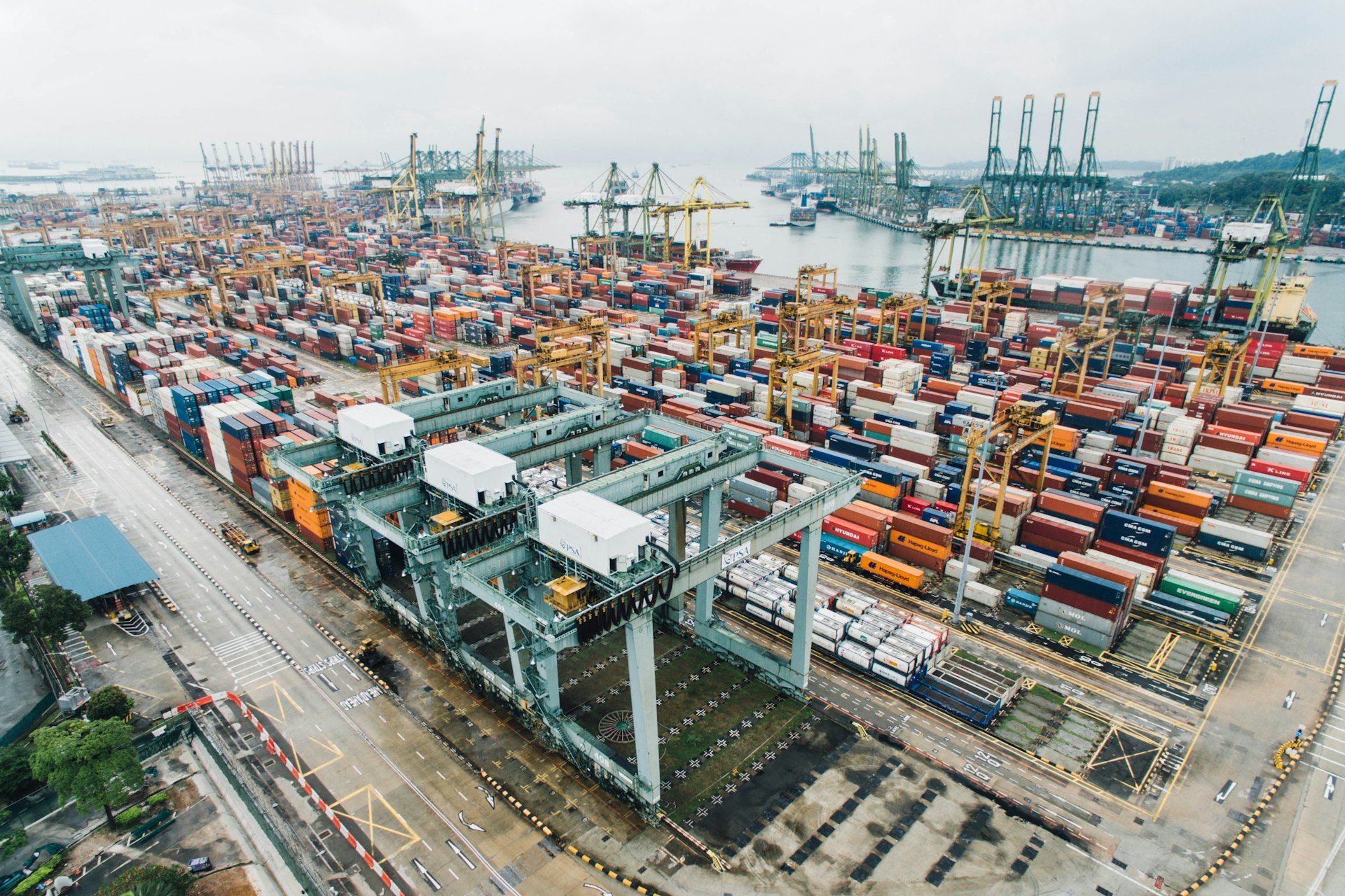 An aerial view of a shipping port with stacked containers